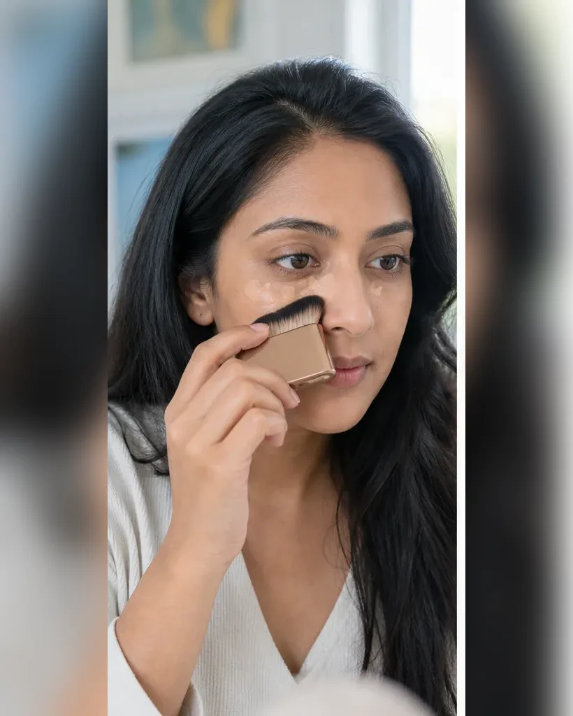 Illustrative adult model using a complexion brush